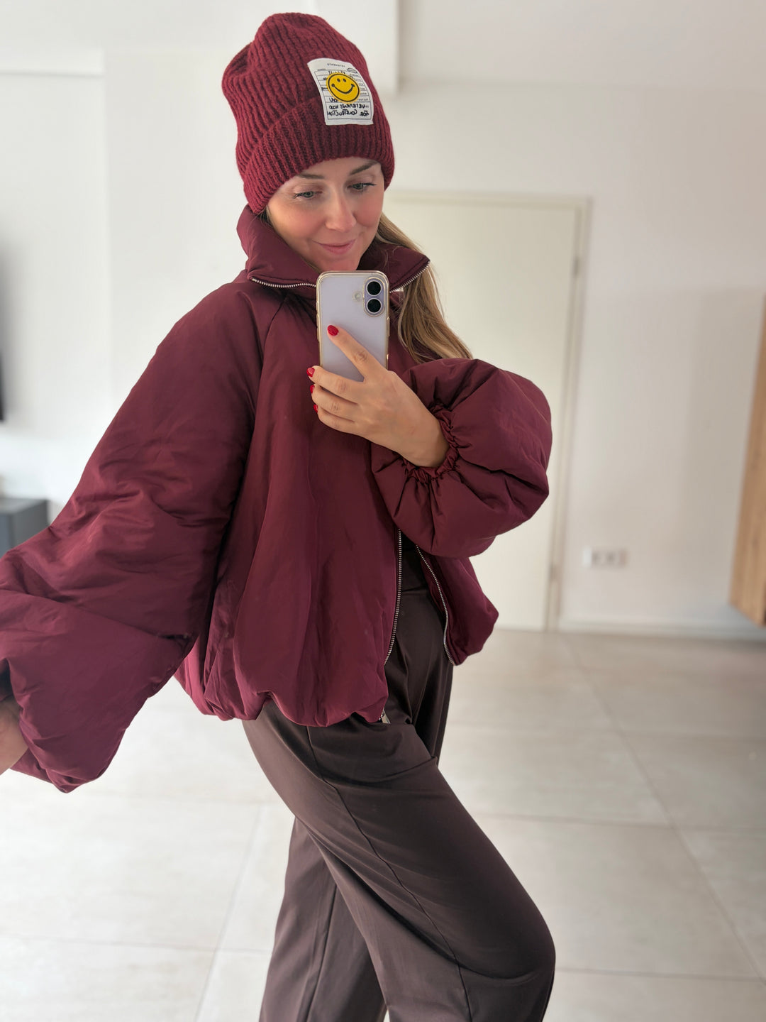 Bordeauxrote Oversize-Ballonjacke am Model – lässige Frontansicht mit weitem Ärmel und hohem Kragen