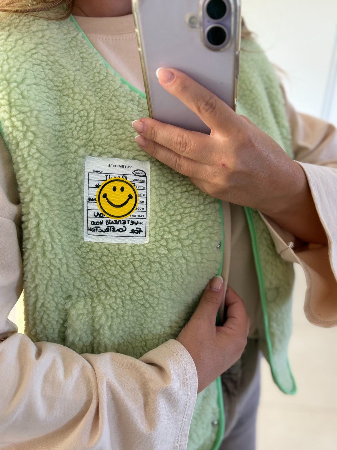 Teddyweste Happy in Pistazie mit gelbem Smiley-Patch – Detailansicht